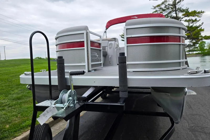 Slide: The Image of 2023 Bennington 22 LSB pontoon boat on trailer, featuring sleek design and red accents. - 6