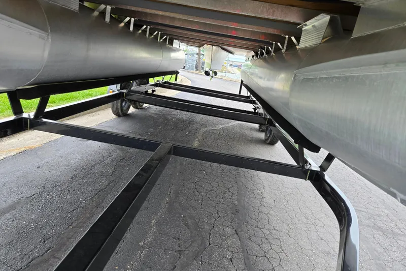 Slide: The Image of Underneath view of a 2023 Bennington 22 LSB pontoon boat on a trailer. - 7