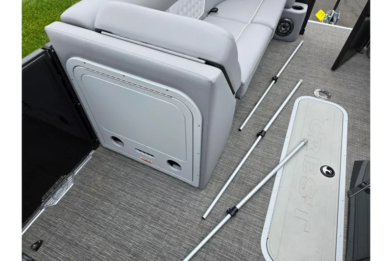 Slide: The Image of 2022 Crest Classic DLX 220 boat interior with gray seating and deck accessories. - 21