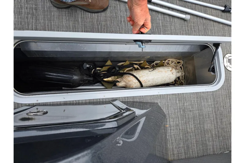 Slide: The Image of Open storage compartment on 2022 Crest Classic DLX 220 boat with ropes and fenders. - 22