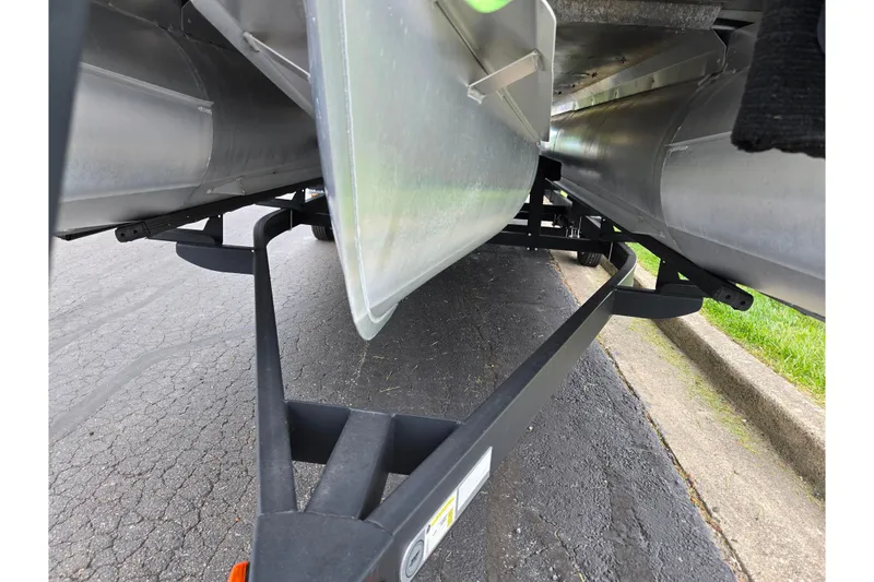 Slide: The Image of Underneath view of a 2022 Crest Classic DLX 220 pontoon boat on a trailer. - 6