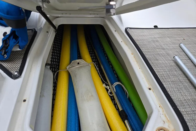 Slide: The Image of Storage compartment in a 2020 Monterey M-20 boat with colorful pool noodles. - 12