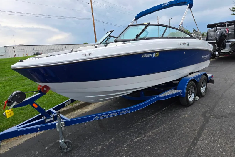 Slide: The Image of 2020 Monterey M-20 boat on trailer, blue and white design, parked outdoors. - 5