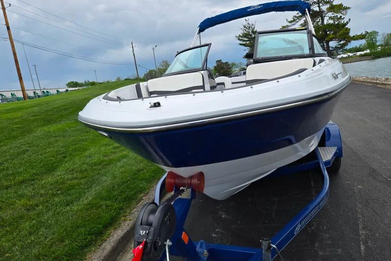 Slide: The Image of 2020 Monterey M-20 boat on trailer by lakeside, showcasing sleek design and blue accents. - 6