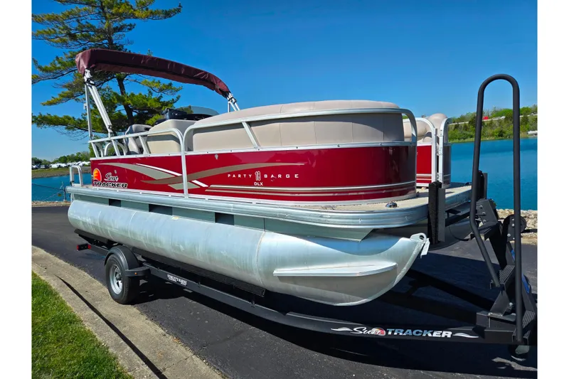 Slide: The Image of 2014 Sun Tracker Party Barge 20 DLX pontoon boat on trailer by a lake. - 11