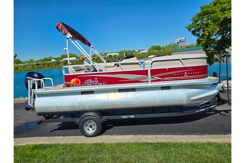 Slide: The Image of 2014 Sun Tracker Party Barge 20 DLX pontoon boat on trailer by a lake. - 12
