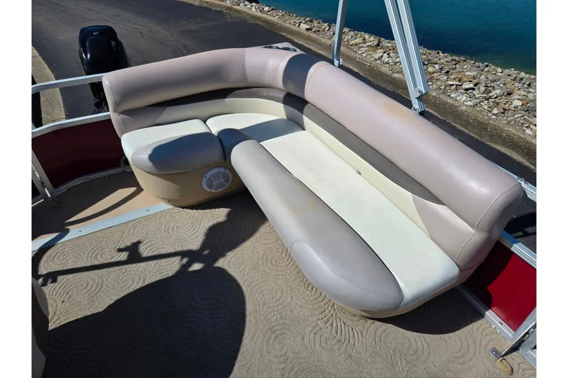 Slide: The Image of 2014 Sun Tracker Party Barge 20 DLX pontoon boat with beige seating and carpeted deck. - 16