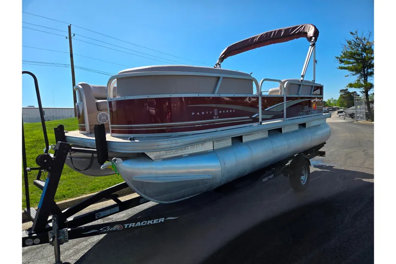 Slide: The Image of 2014 Sun Tracker Party Barge 20 DLX pontoon boat on trailer, parked outdoors. - 7
