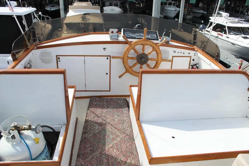 Slide: The Image of 1971 Grand Banks 36 Classic boat helm with wooden wheel and seating area. - 10