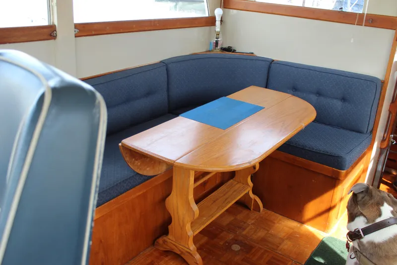 Slide: The Image of Interior of 1971 Grand Banks 36 Classic with wooden table and blue cushioned seating. - 14