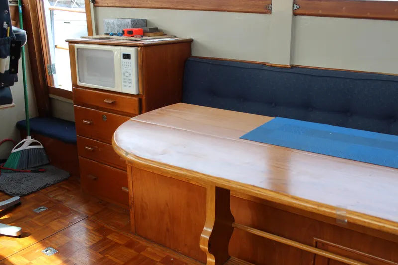 Slide: The Image of Interior of a 1971 Grand Banks 36 Classic yacht with wooden table and built-in microwave. - 15
