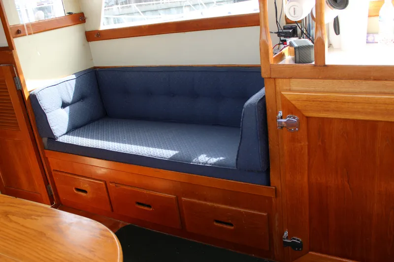 Slide: The Image of Interior of 1971 Grand Banks 36 Classic with blue cushioned seating and wooden cabinetry. - 16
