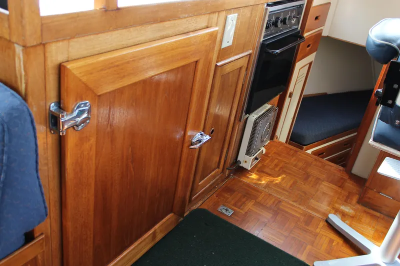 Slide: The Image of Interior of a 1971 Grand Banks 36 Classic boat, featuring wood cabinetry and seating. - 17