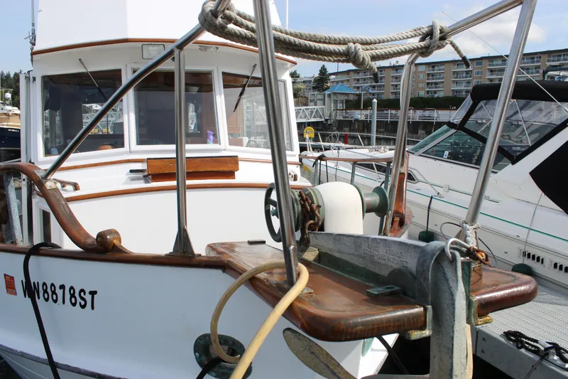 Slide: The Image of 1971 Grand Banks 36 Classic yacht docked at marina, showcasing anchor and deck details. - 2