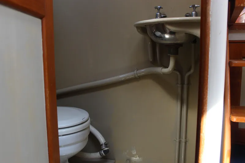 Slide: The Image of 1971 Grand Banks 36 Classic boat bathroom with toilet and sink. - 22