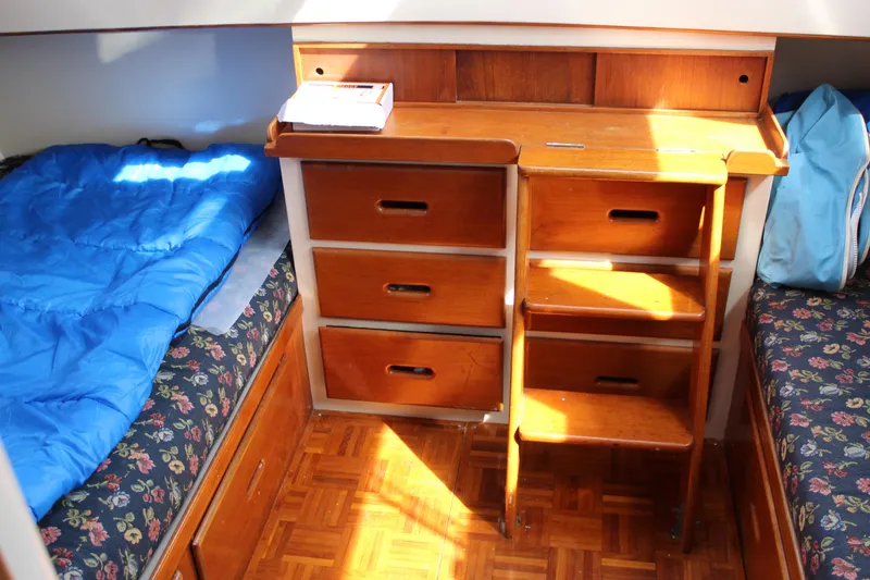 Slide: The Image of Interior of 1971 Grand Banks 36 Classic with wooden drawers and floral-patterned bedding. - 26
