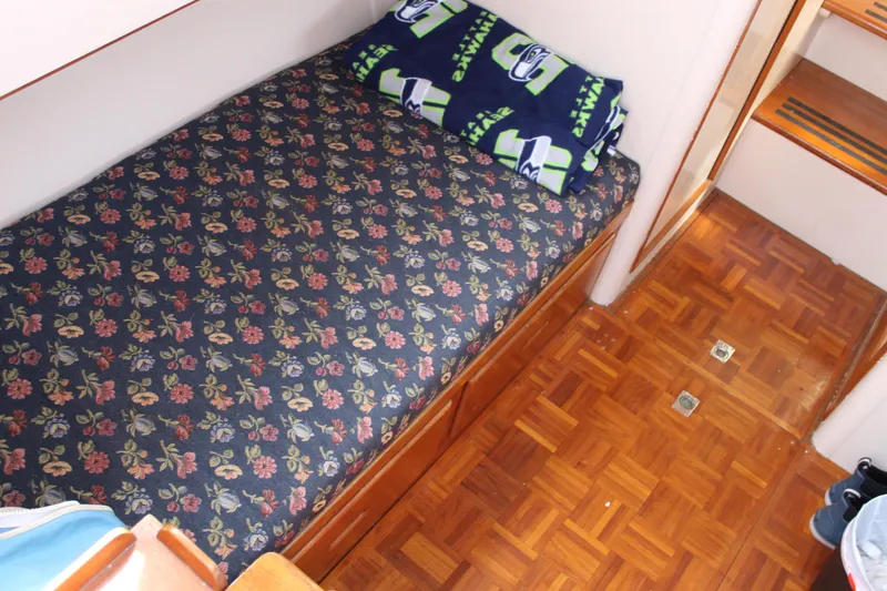 Slide: The Image of Cozy cabin interior of 1971 Grand Banks 36 Classic with floral bedding and wooden flooring. - 28