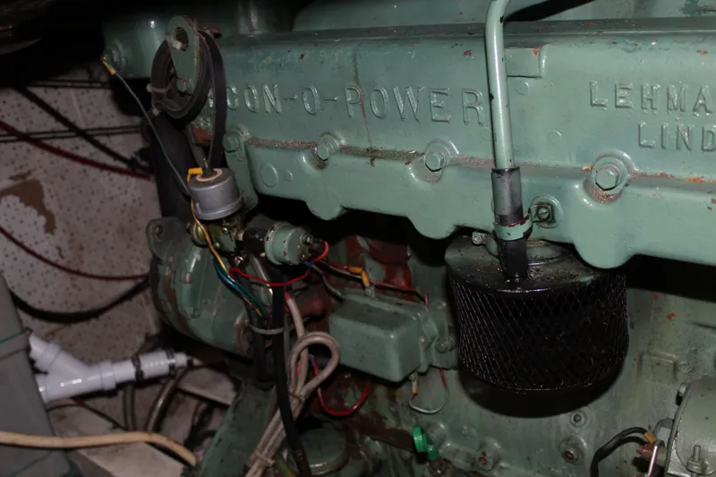Slide: The Image of Engine compartment of a 1971 Grand Banks 36 Classic boat, featuring Lehman engine components. - 32