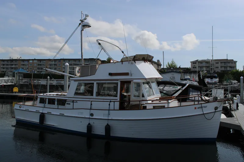 Slide: The Image of 1971 Grand Banks 36 Classic yacht docked at marina under cloudy sky. - 5