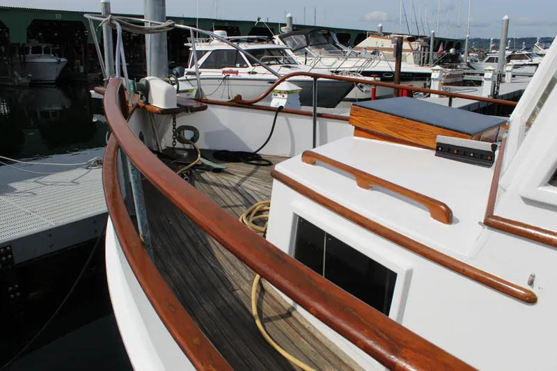 Slide: The Image of 1971 Grand Banks 36 Classic yacht with wooden railings docked at a marina. - 7