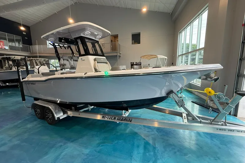 The Image of 2026 Key West 249 FS boat on trailer in showroom setting. - 0