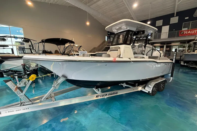 Slide: The Image of 2026 Key West 249 FS boat displayed indoors on a trailer. - 1