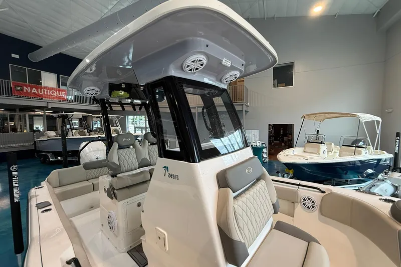 Slide: The Image of 2026 Key West 249 FS boat interior with seating and console in showroom. - 10