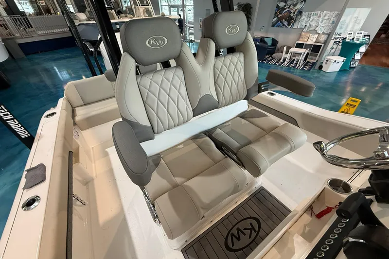 Slide: The Image of 2026 Key West 249 FS boat interior with luxurious seating and steering wheel. - 11