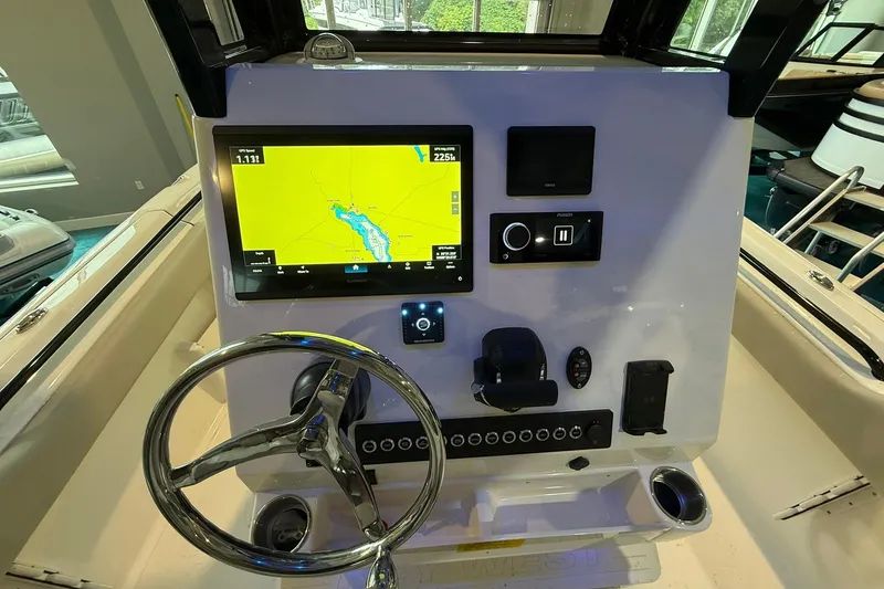Slide: The Image of 2026 Key West 249 FS boat dashboard with GPS display and steering wheel. - 14