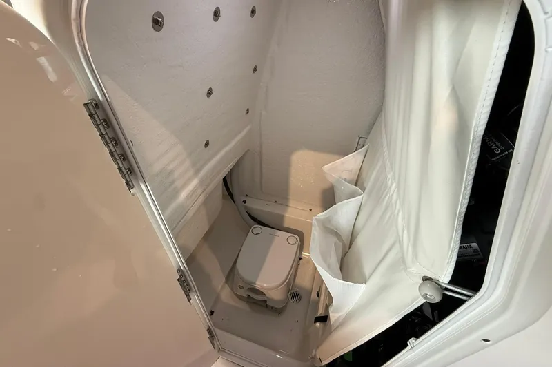 Slide: The Image of Interior of 2026 Key West 249 FS boat, featuring compact marine toilet. - 15