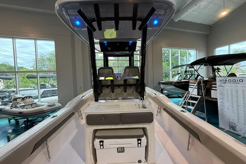 Slide: The Image of 2026 Key West 249 FS boat interior with seating and cooler in showroom. - 17