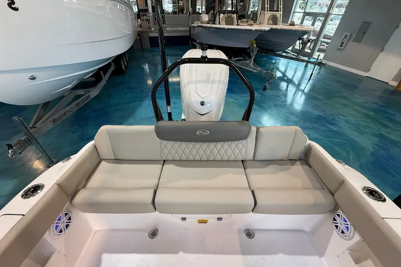 Slide: The Image of 2026 Key West 249 FS boat interior with cushioned seating in showroom. - 18