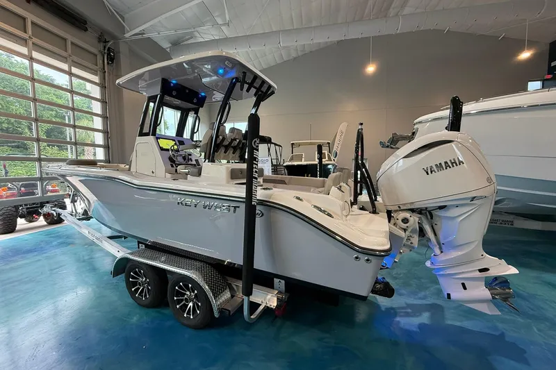 Slide: The Image of 2026 Key West 249 FS boat with Yamaha engine on trailer in showroom. - 2