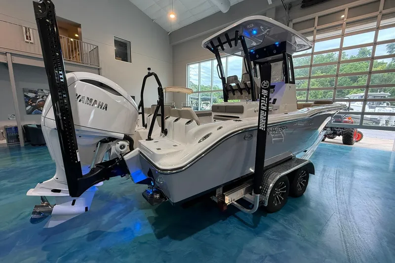Slide: The Image of 2026 Key West 249 FS boat with Yamaha engine in showroom setting. - 4