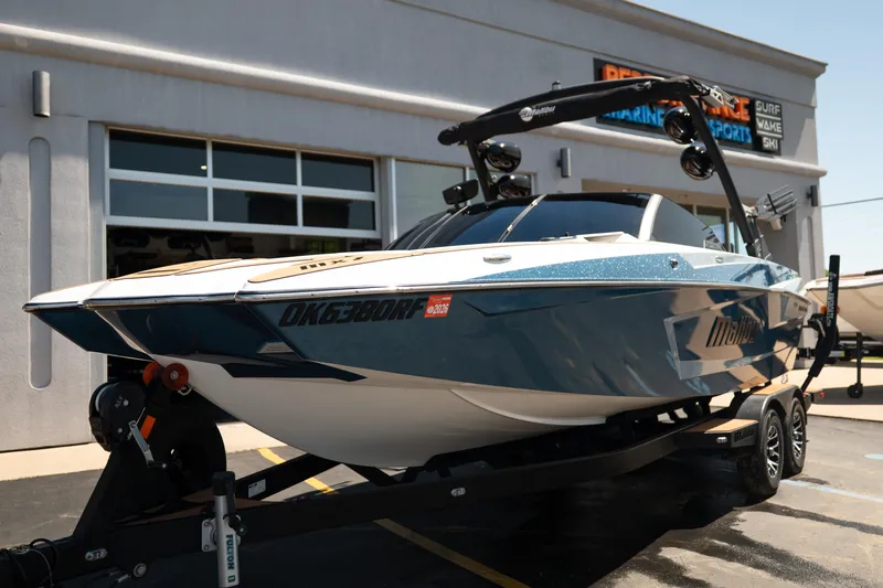Slide: The Image of 2022 Malibu Wakesetter 23 MXZ boat on trailer outside dealership. - 11