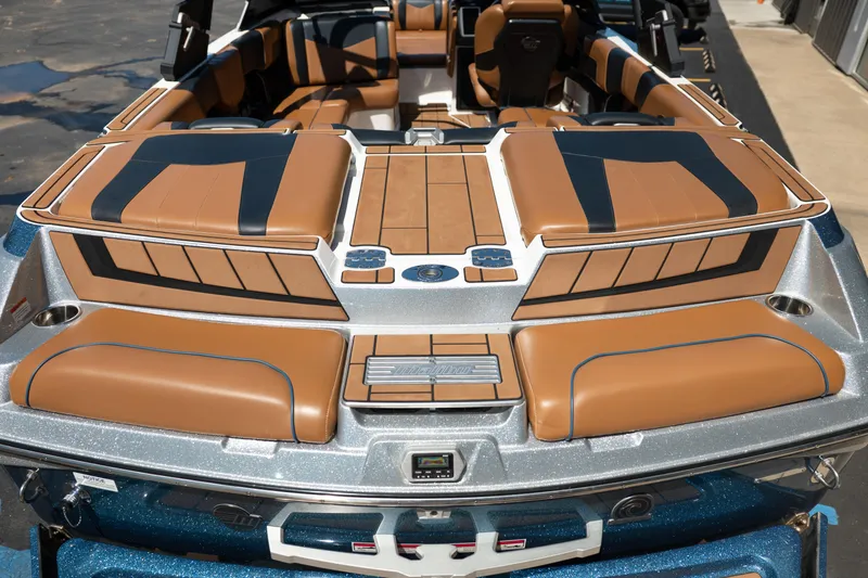 Slide: The Image of 2022 Malibu Wakesetter 23 MXZ boat interior with tan and black seating. - 13