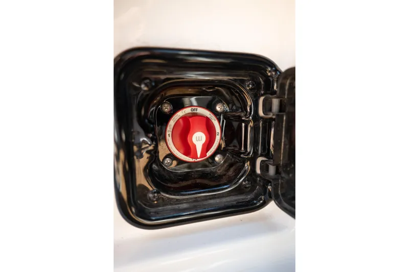 Slide: The Image of Battery switch on a 2022 Malibu Wakesetter 23 MXZ boat, featuring a red dial. - 18