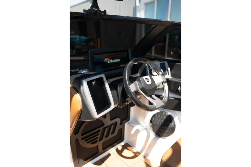 Slide: The Image of 2022 Malibu Wakesetter 23 MXZ dashboard with modern steering wheel and digital displays. - 19