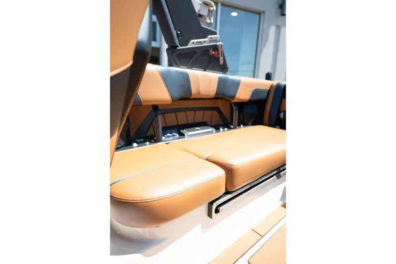 Slide: The Image of 2022 Malibu Wakesetter 23 MXZ interior seating, featuring tan and black upholstery. - 24