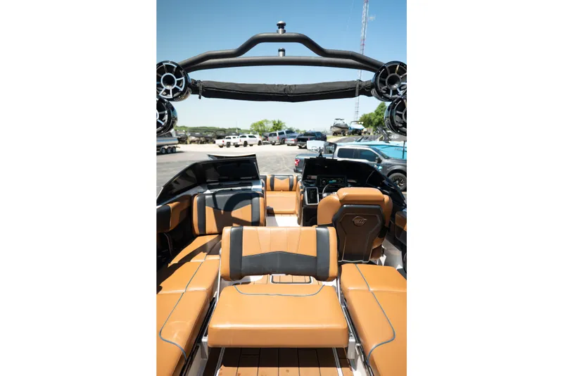 Slide: The Image of 2022 Malibu Wakesetter 23 MXZ interior with tan leather seating and advanced dashboard. - 27