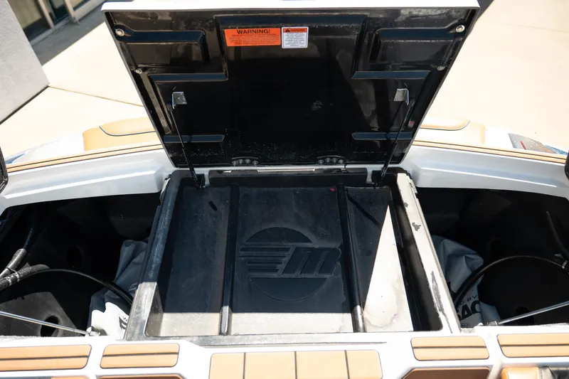 Slide: The Image of Open storage compartment of 2022 Malibu Wakesetter 23 MXZ boat. - 28