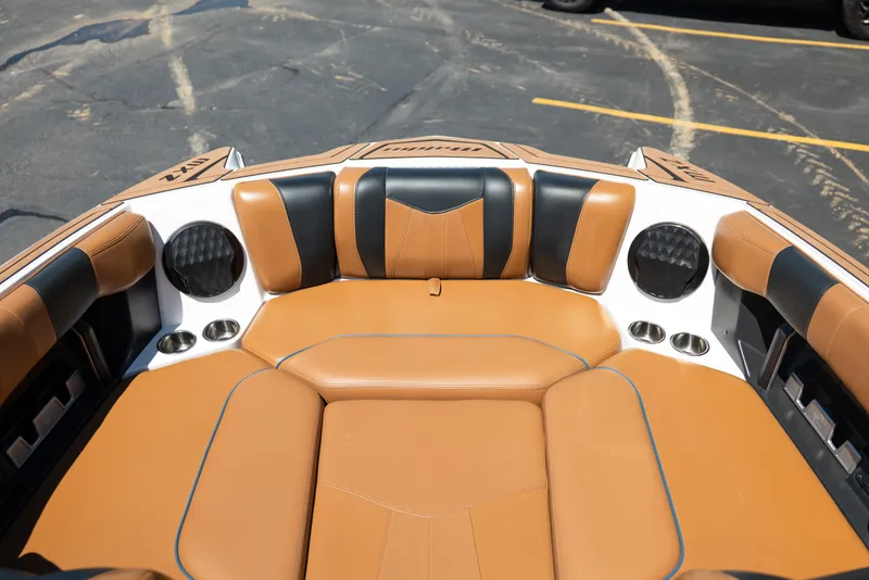 Slide: The Image of 2022 Malibu Wakesetter 23 MXZ boat interior with tan and black seating. - 32