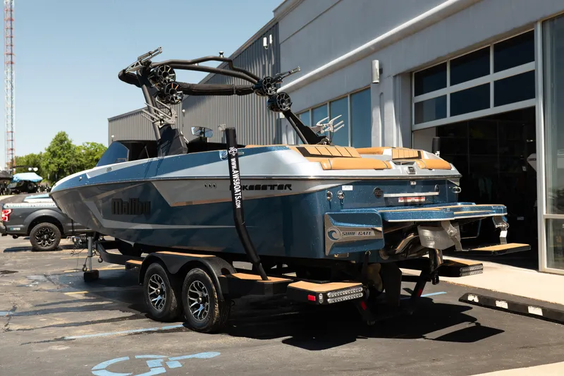 Slide: The Image of 2022 Malibu Wakesetter 23 MXZ boat on trailer outside dealership. - 4