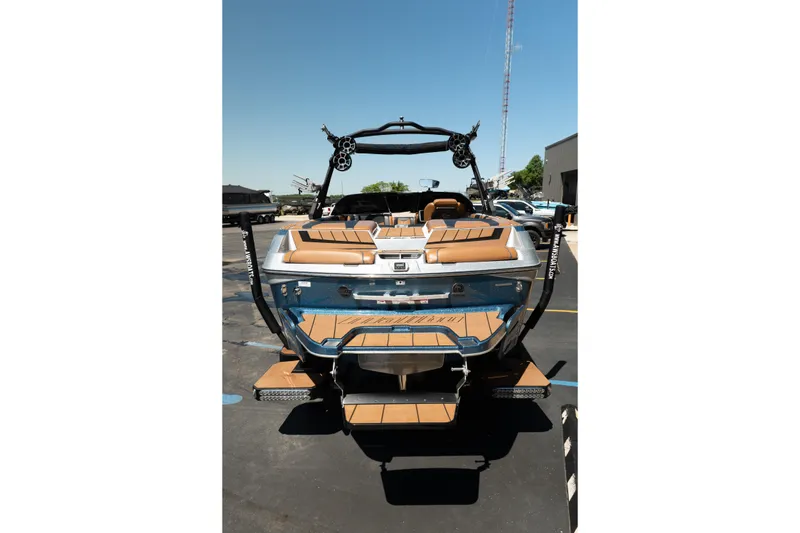 Slide: The Image of 2022 Malibu Wakesetter 23 MXZ boat, rear view, parked outdoors on a sunny day. - 6