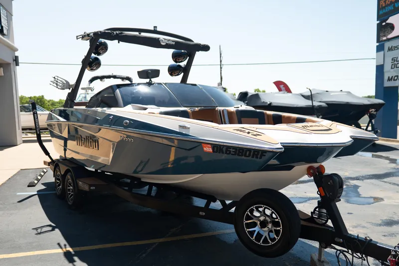 Slide: The Image of 2022 Malibu Wakesetter 23 MXZ boat on trailer, parked outdoors in sunlight. - 9