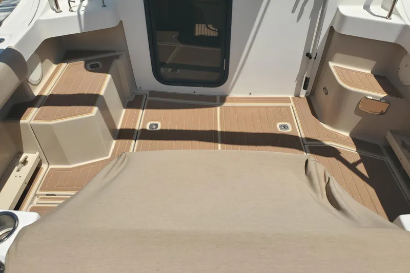 Slide: The Image of Interior view of a 2013 Cutwater 26 boat, featuring tan seating and deck. - 20