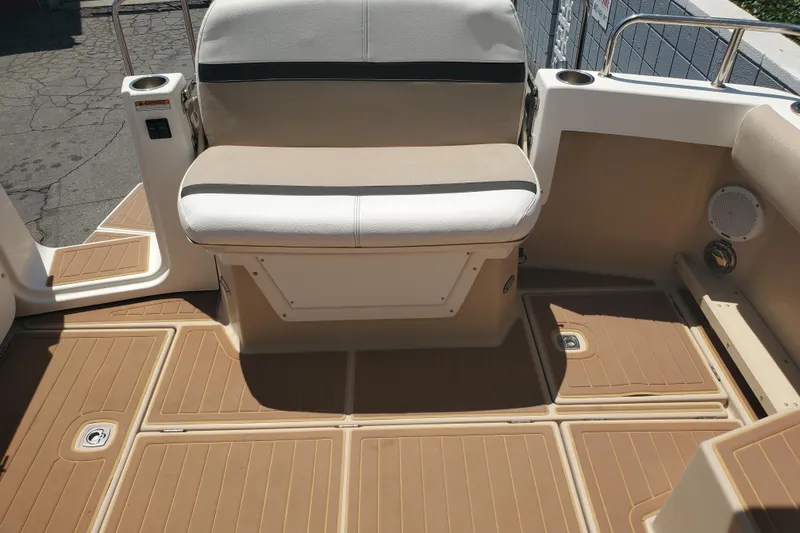 Slide: The Image of 2013 Cutwater 26 boat interior with beige seating and non-slip flooring. - 21