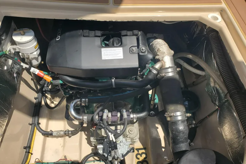 Slide: The Image of Engine compartment of a 2013 Cutwater 26 boat, showcasing detailed mechanical components. - 23