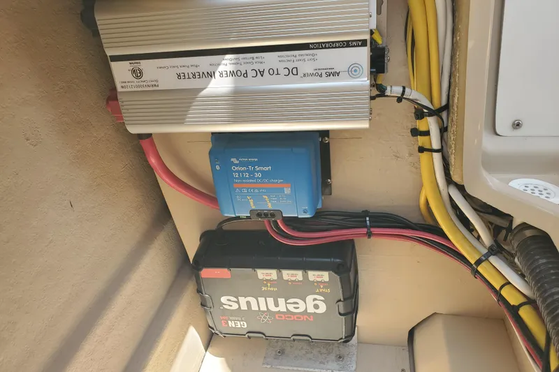 Slide: The Image of Electrical setup in a 2013 Cutwater 26 boat, featuring inverter and battery charger. - 25