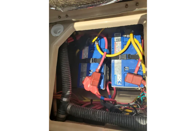 Slide: The Image of Battery compartment of a 2013 Cutwater 26 boat with wiring and connections. - 27